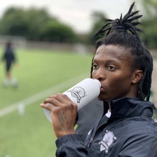 A player takes a drink from his Palma branded, reusable bottle